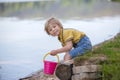 Little toddler child, cute boy, playing with toys in the sand on a lake Royalty Free Stock Photo