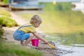 Little toddler child, cute boy, playing with toys in the sand on a lake Royalty Free Stock Photo