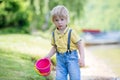 Little toddler child, cute boy, playing with toys in the sand on a lake Royalty Free Stock Photo