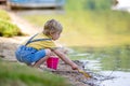 Little toddler child, cute boy, playing with toys in the sand on a lake Royalty Free Stock Photo