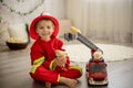 Little toddler child, playing with fire truck car toy and little chicks at home Royalty Free Stock Photo