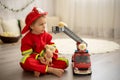 Little toddler child, playing with fire truck car toy and little chicks at home Royalty Free Stock Photo