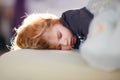 Little toddler child resting on say in parents bed. Adorable kid boy sleeping and dreaming. Peaceful and relaxed rest Royalty Free Stock Photo