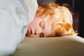 Little toddler child resting on say in parents bed. Adorable kid boy sleeping and dreaming. Peaceful and relaxed rest Royalty Free Stock Photo