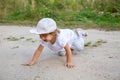 little toddler crawling in sand in counrtyside