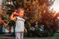 Little toddler girl blowing soap bubbles in summer park. Happy kid playing outdoors Royalty Free Stock Photo