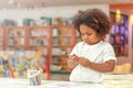 Little toddler girl concentrate on drawing. Mix African girl learn and play in the pre-school class. Children enjoy hand writing.