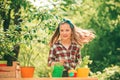 Little toddler girl gardening and having fun in spring yard. Kid planting flowers in pot. Cute little girl watering