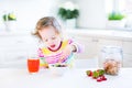 Little toddler girl having breakfast drinking juice Royalty Free Stock Photo