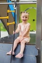 Little toddler girl having fun at playground. Educational playground equipment. Sensory experience