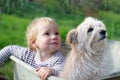 Little toddler girl and her dog sitting in a pushcart Royalty Free Stock Photo