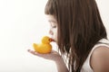 Little toddler girl kissing a yellow bath duck
