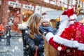 Little toddler girl with mother on Christmas market. Royalty Free Stock Photo