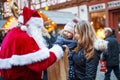 Little toddler girl with mother on Christmas market. Royalty Free Stock Photo