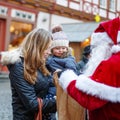 Little toddler girl with mother on Christmas market. Royalty Free Stock Photo