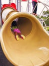 Little toddler girl playing at the slide. Doing upside down position Royalty Free Stock Photo