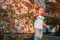 Little toddler girl playing with soap bubbles in summer park. Happy kid having fun outdoors Royalty Free Stock Photo