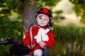 Little toddler girl with security helmet on head sitting in bike seat of her mother or father bicycle. Safe and child Royalty Free Stock Photo