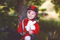 Little toddler girl with security helmet on head sitting in bike seat of her mother or father bicycle. Safe and child Royalty Free Stock Photo