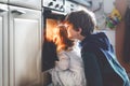 Little toddler girl and two kids boys baking, pizza or cookies in kitchen. Three children, siblings, brothers and sister Royalty Free Stock Photo