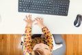 Little toddler girl using her computer from above