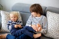 Little toddler and his older brother, having fun at home, tickling and giggle Royalty Free Stock Photo