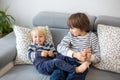 Little toddler and his older brother, having fun at home, tickling and giggle Royalty Free Stock Photo