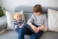 Little toddler and his older brother, having fun at home, tickling and giggle Royalty Free Stock Photo