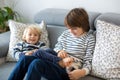 Little toddler and his older brother, having fun at home, tickling and giggle Royalty Free Stock Photo