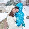 Little toddler kid boy and mother having fun with snow on winter day Royalty Free Stock Photo