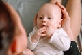 Little toddler lies on mother`s lap and smile cutely at each other Royalty Free Stock Photo