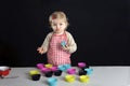 Little toddler making cupcakes,