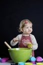 Little toddler making pastry,