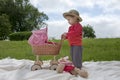 Little toddler playing with a pram outdoors Royalty Free Stock Photo