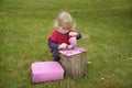 Little toddler playing Tea time outdoors in the garden Royalty Free Stock Photo