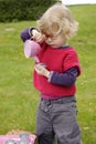 Little toddler playing tea time outdoors in the garden Royalty Free Stock Photo