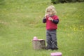 Little toddler playing tea time outdoors in the garden Royalty Free Stock Photo