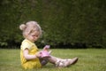 Little toddler playing tea time outdoors Royalty Free Stock Photo