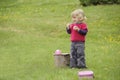 Little toddler playing tea time outdoors in the garden Royalty Free Stock Photo