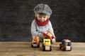 Little toddler playing with wooden cars Royalty Free Stock Photo