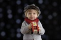 Little toddler playing with wooden cars