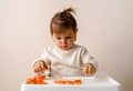 Little toddler plays play dough. Modeling orange sun. Creativity imagination