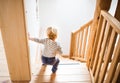 Toddler boy in dangerous situation at home. Child safety concept.