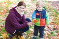 Little toddler and young mother in autumn park Royalty Free Stock Photo