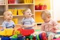 Little toddlers boys and a girl playing together in kindergarten room. Preschool children in day care centre Royalty Free Stock Photo