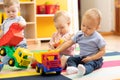 Little toddlers boys and a girl playing together in nursery room. Preschool children in day care centre Royalty Free Stock Photo