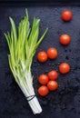 Little tomatoes on dark wet surfaces Royalty Free Stock Photo