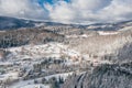 Little town in the Carpathian mountains at winter time. Majestic aerial landscape