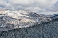 Little town in the Carpathian mountains at winter time. Majestic aerial landscape