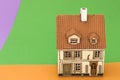 Little toy house on orange green backgrounds Royalty Free Stock Photo